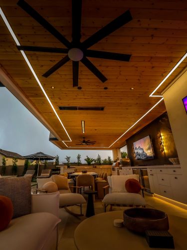 Covered patio at dusk featuring linear ceiling lights and comfortable lounge seating