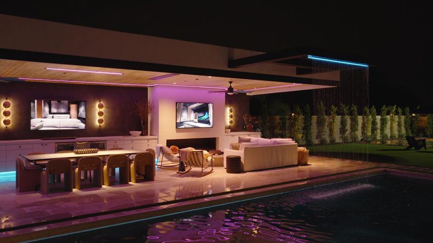 Modern patio with a waterfall feature dropping into a swimming pool