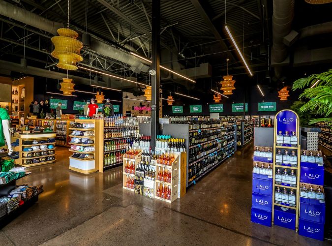 Wide interior view of the retail section showing rows of wine, spirits, and Trevor's branded merchandise.